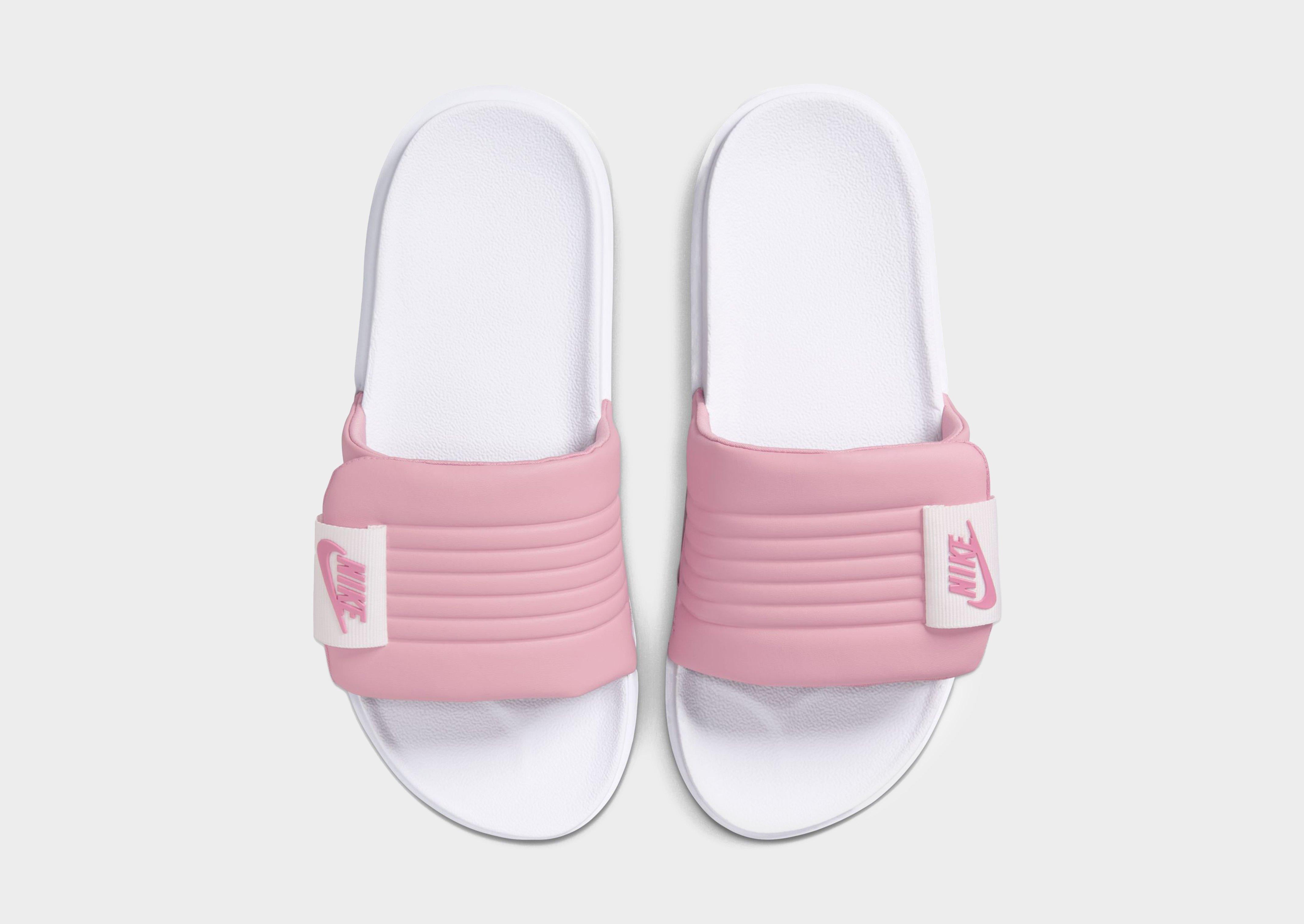 pink and white nike slippers